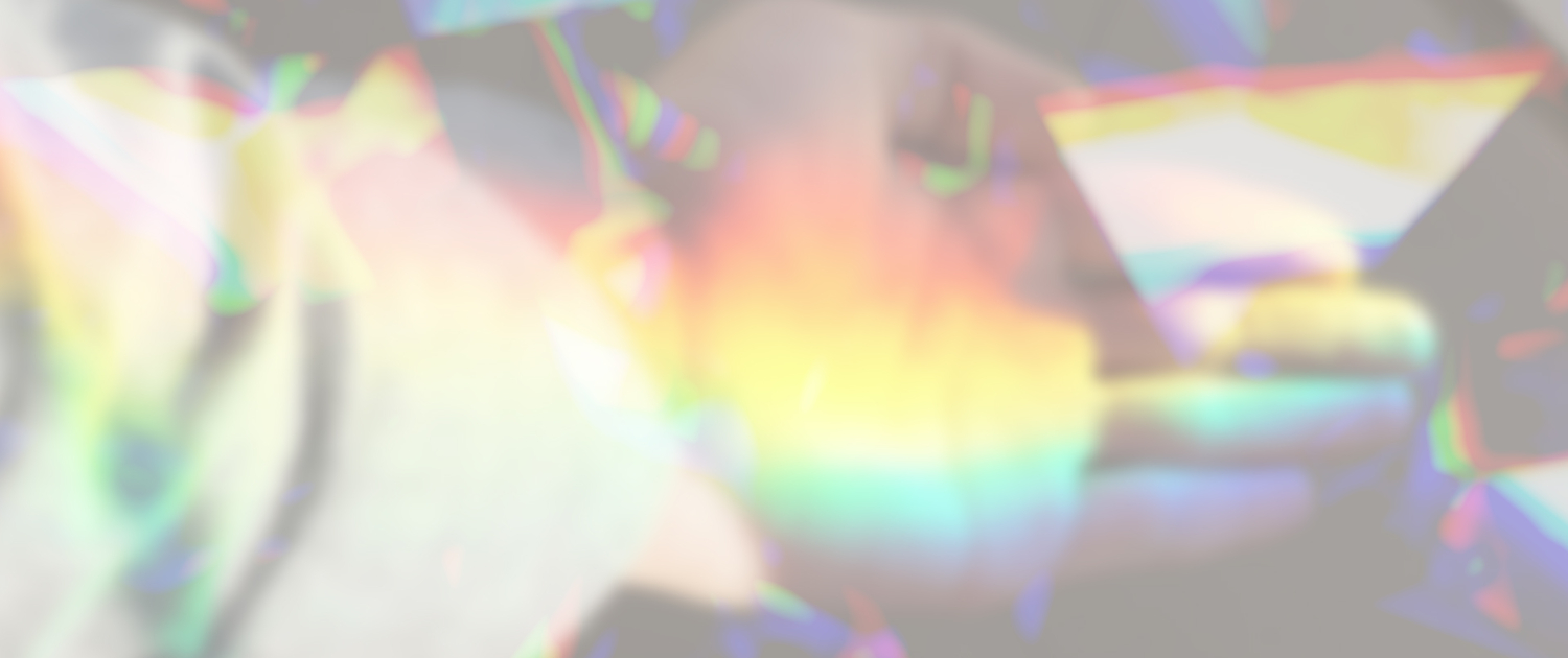 A prism of light over the photo of an extended hand